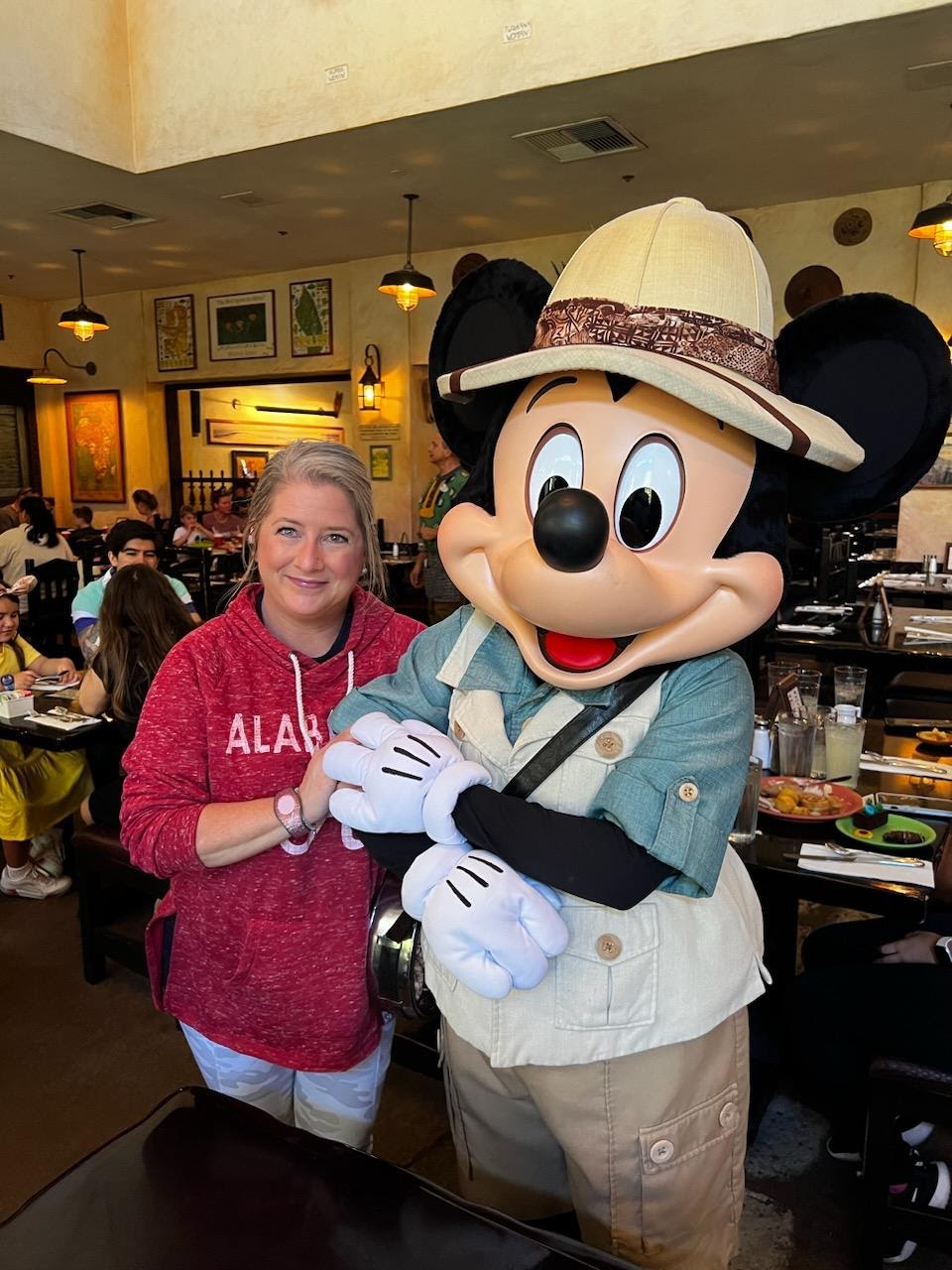 Me standing with Mickey Mouse at Tusker House